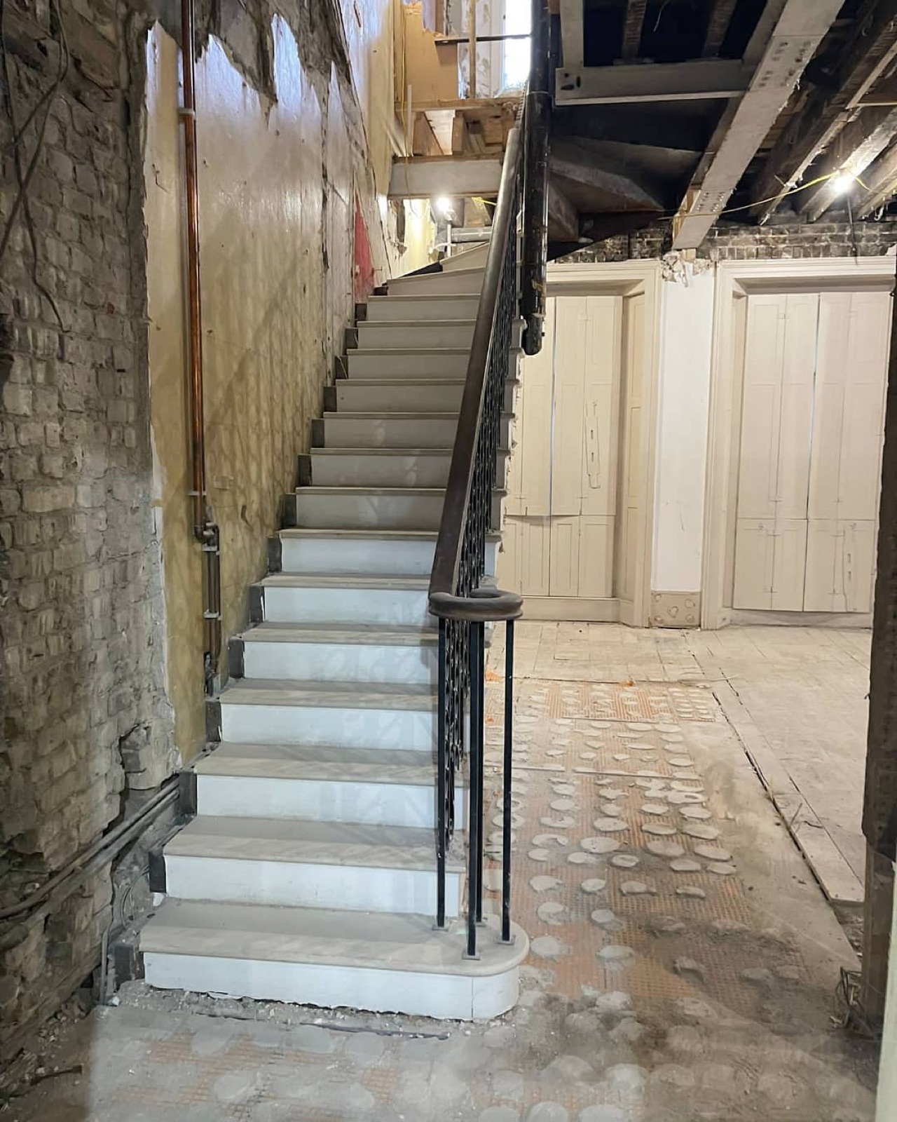 The stone stair and iron balustrade during the strip-out